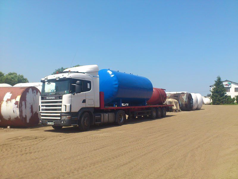 Large truck carrying a huge tank on its rear